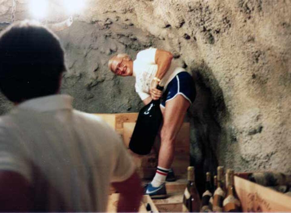 Gil Nickel with large wine bottle in cave