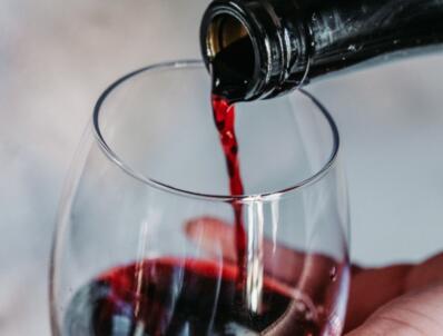 Wine being poured into glass from bottle