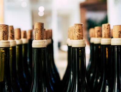 Rows of bottles with partially inserted corks