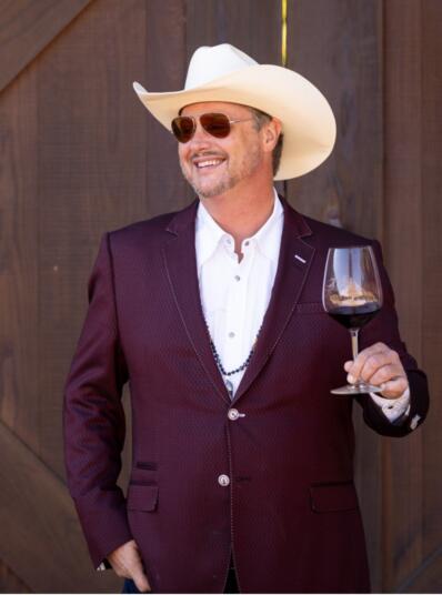 Jeremy Nickel in cowboy had holding wine glass